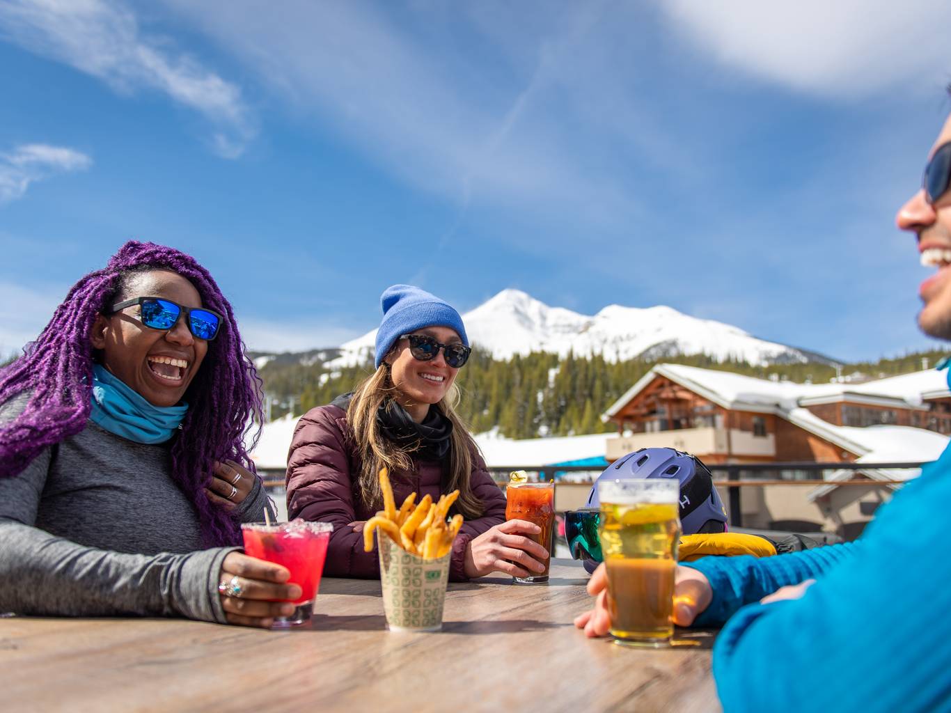 Group of people sitting at the Vista Deck with food and drinks