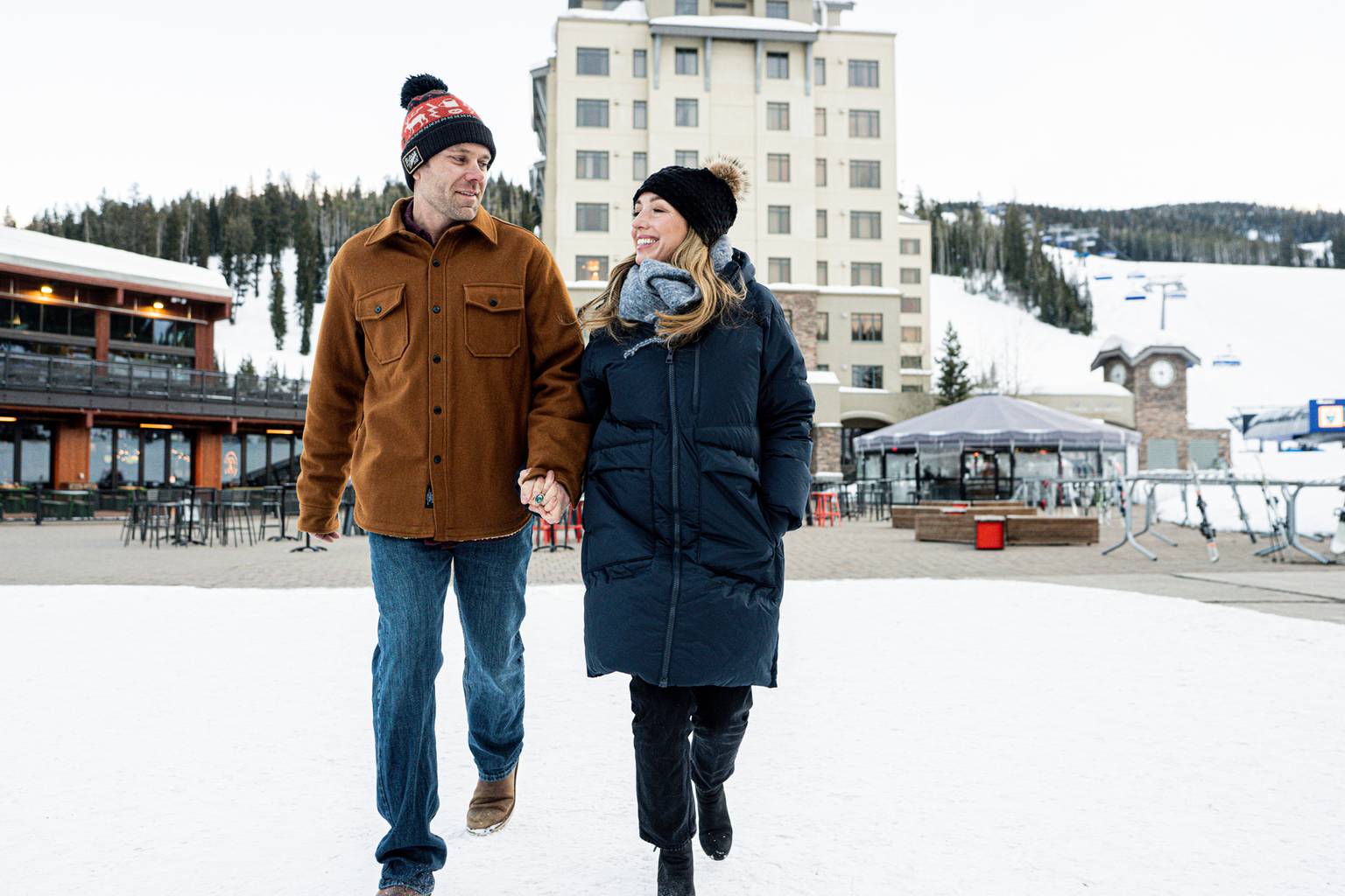 Couple walking through the Big Sky Resort Mountain Village
