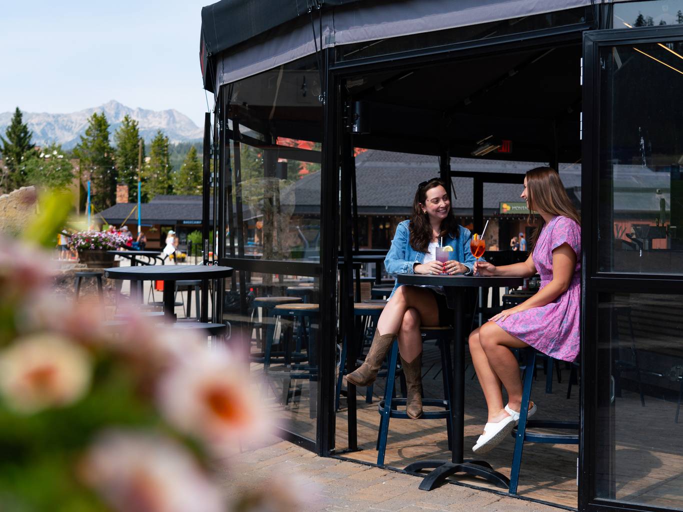 People in sitting outside the Umbrella Bar with drinks in the summer