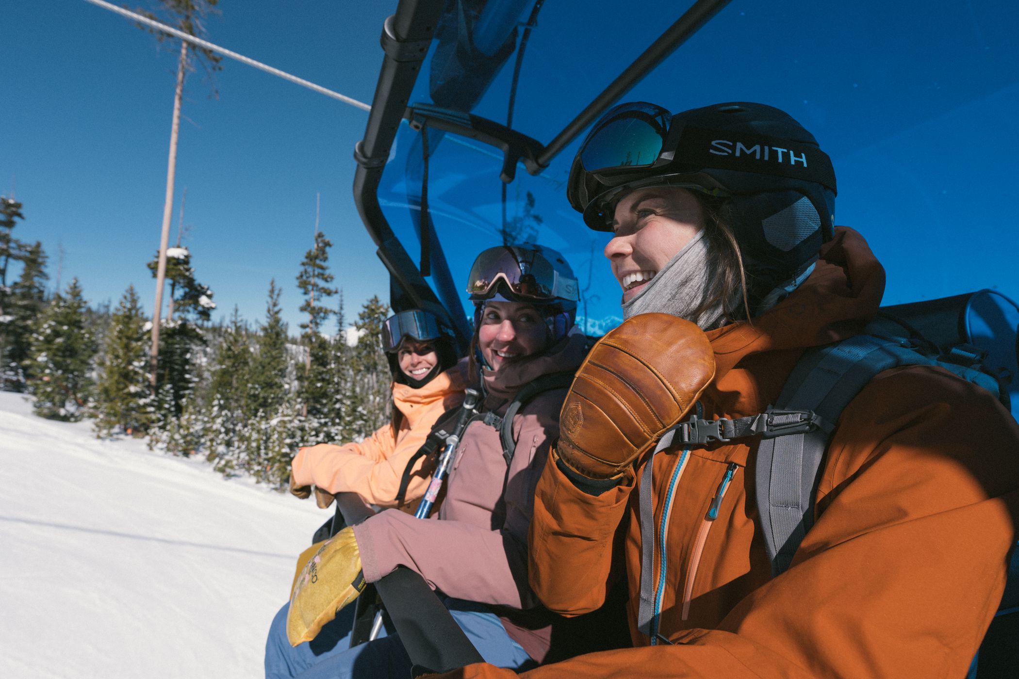 Snowboarders riding a chairlift