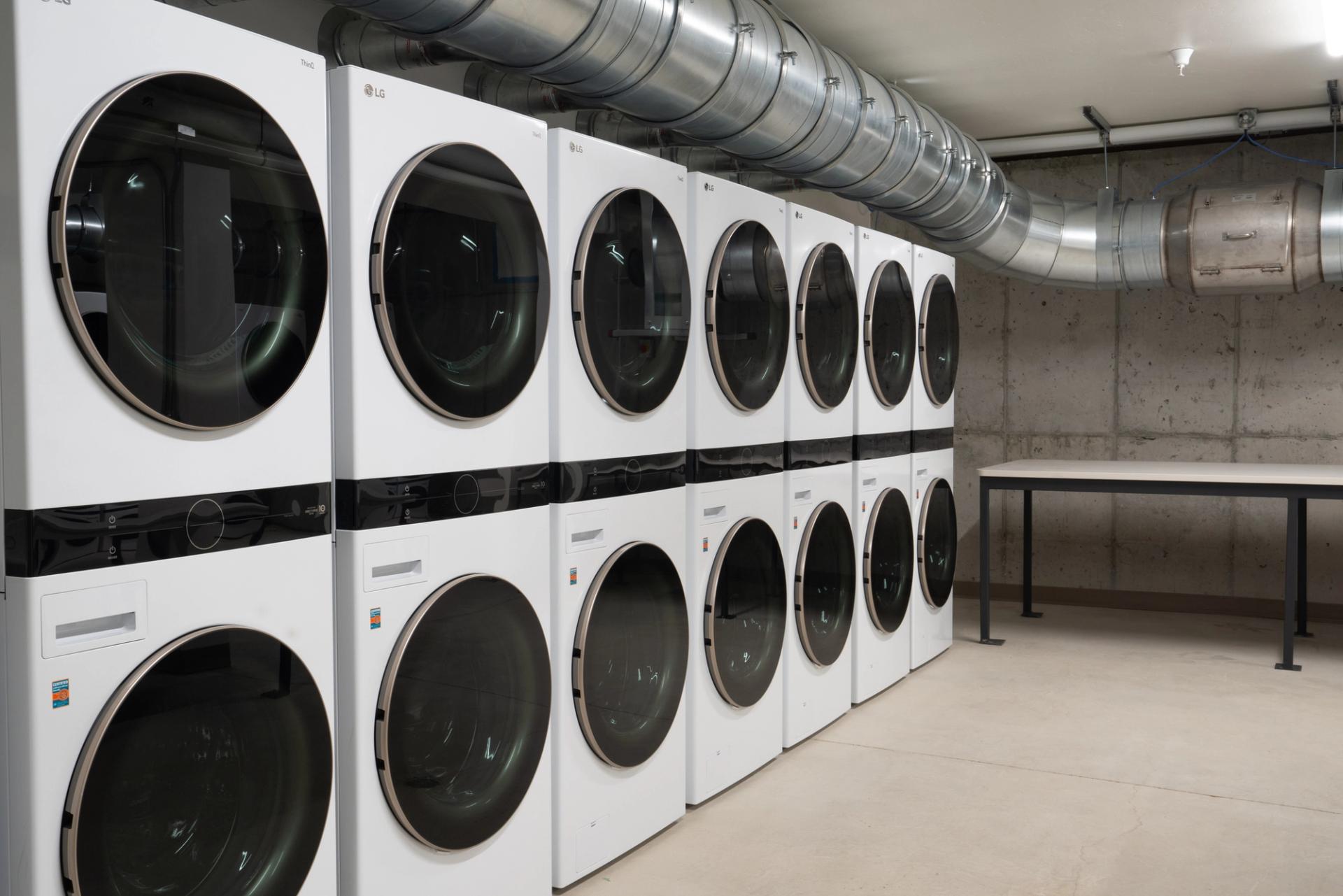 Laundry machines line a wall