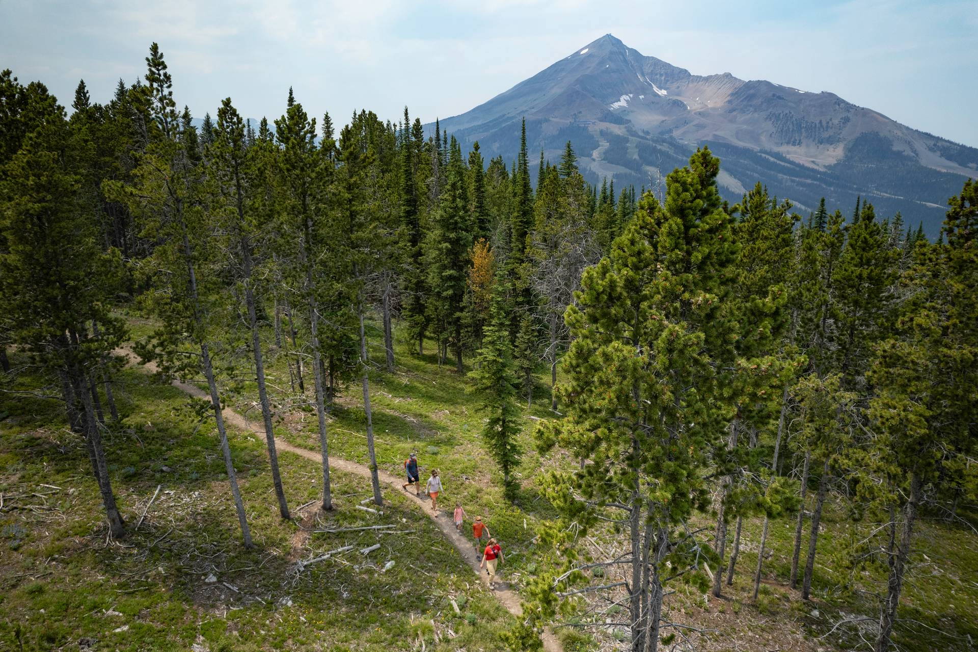 People hiking with Lone Mountain in the background