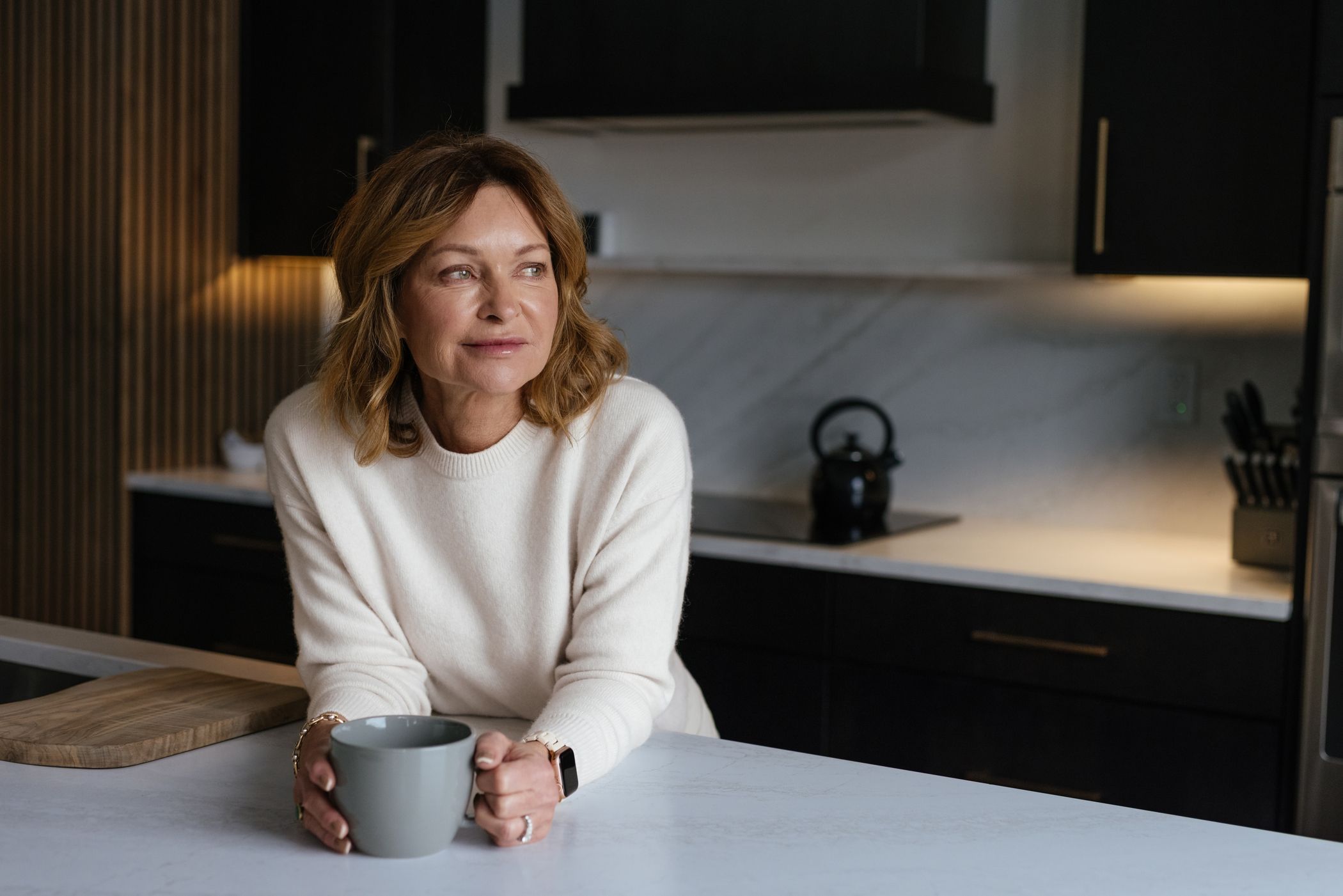 Woman relaxing in a kitchen