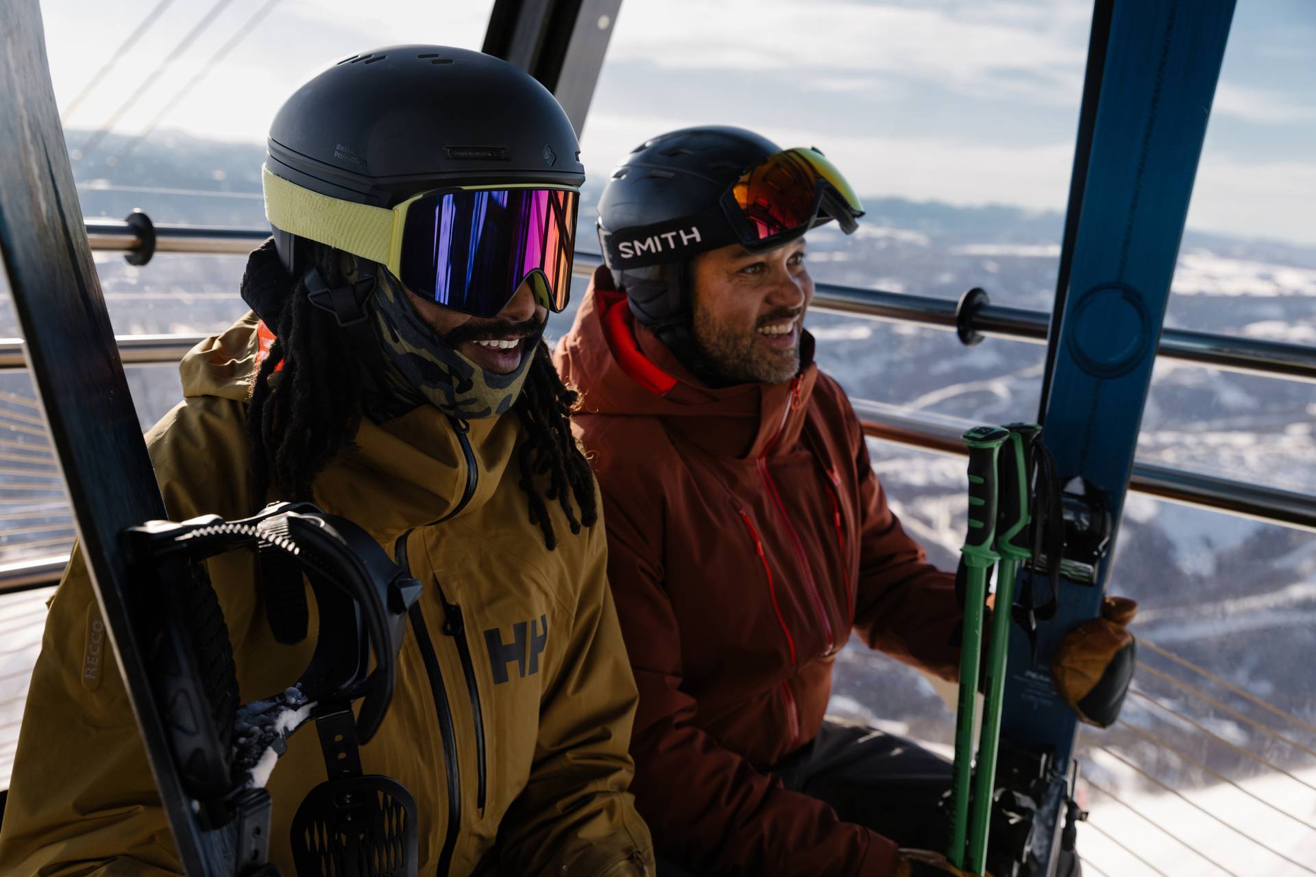 Skier and snowboarder riding the Lone Peak Tram