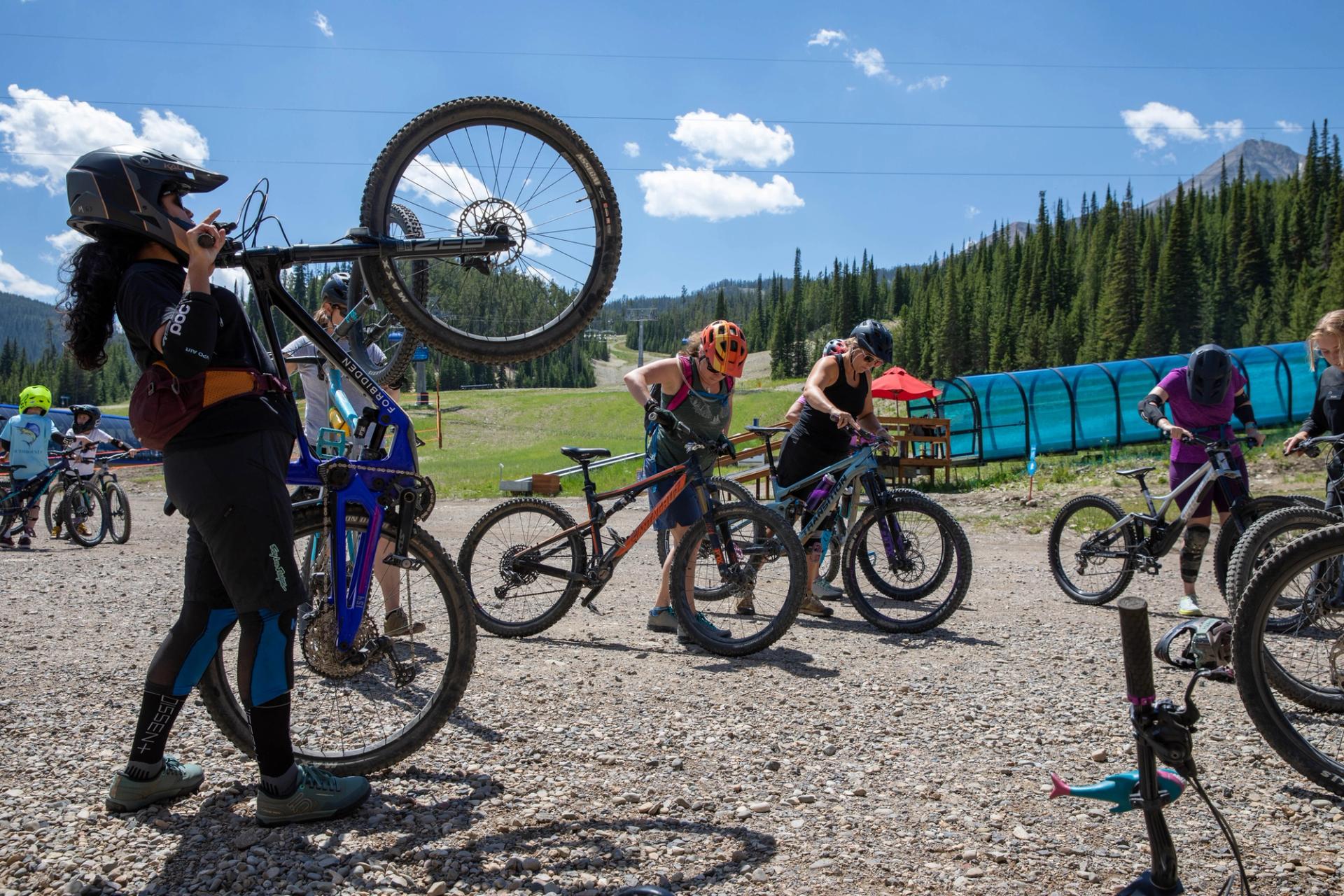 A coach goes over technique for loading bikes onto the lifts