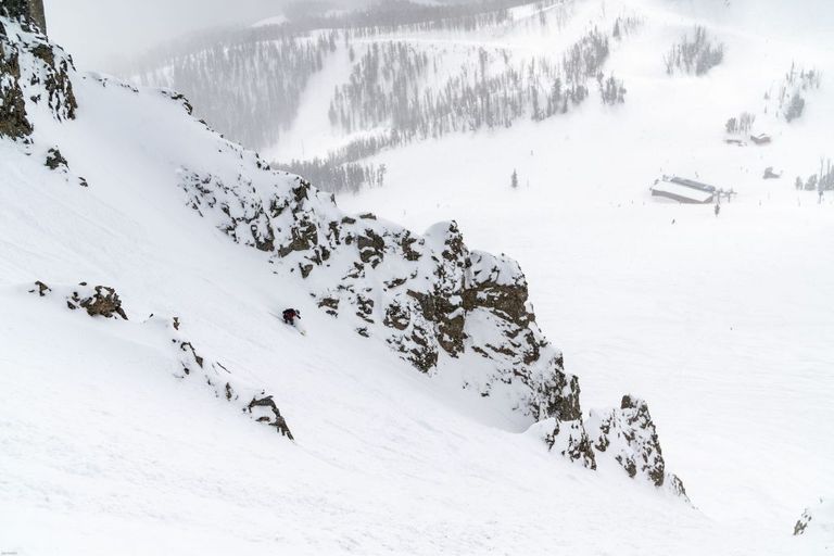 a snowboarder rides down an a to Z chute