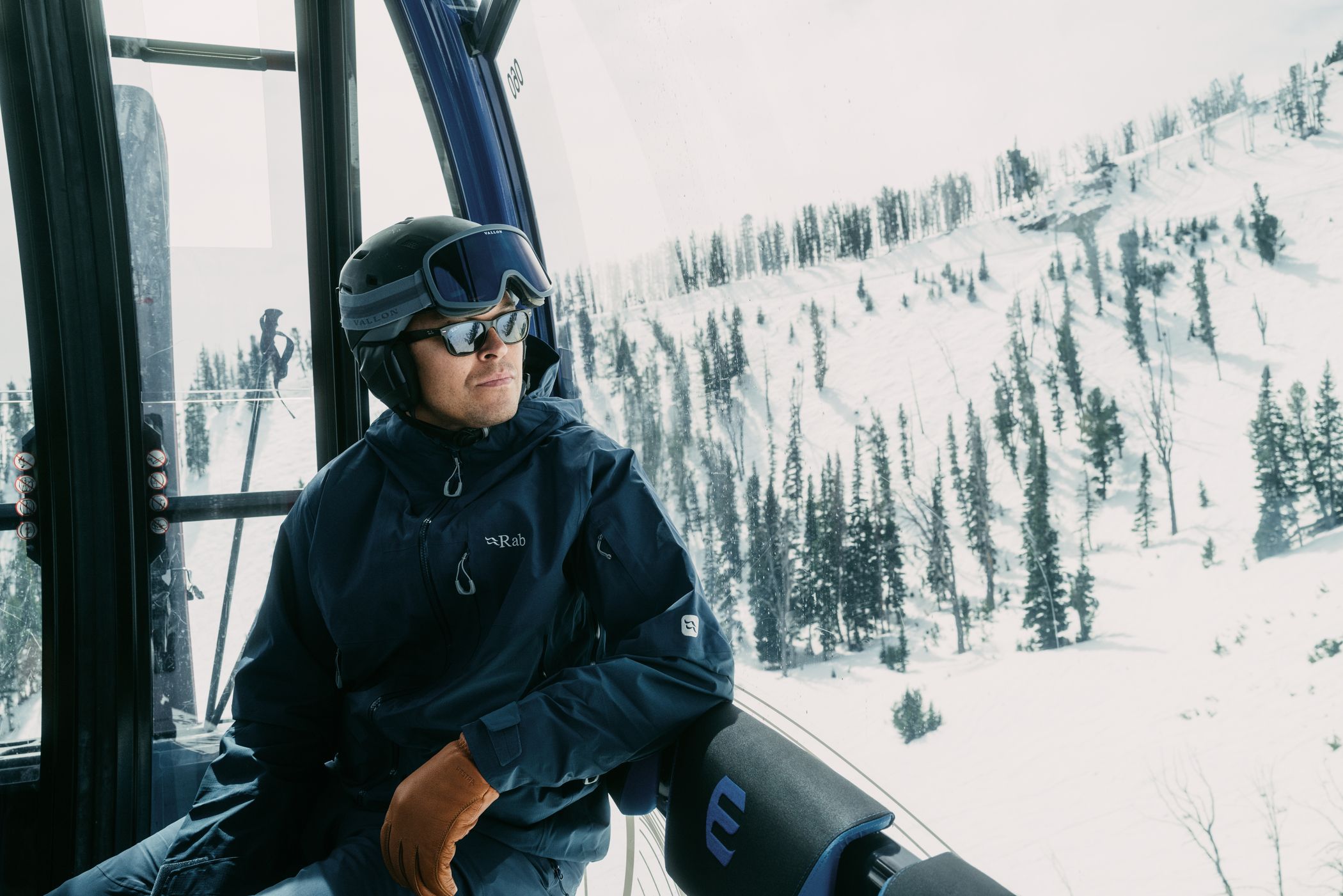 Man in ski gear riding the Explorer Gondola at Big Sky Resort