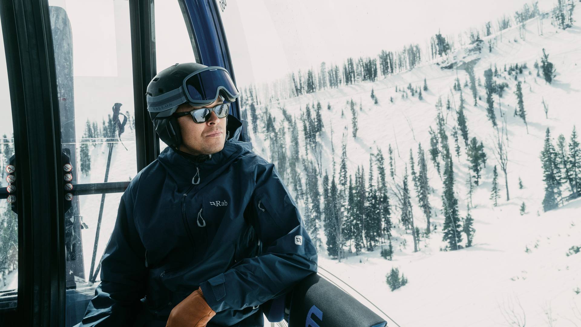 Man in ski gear riding the Explorer Gondola at Big Sky Resort