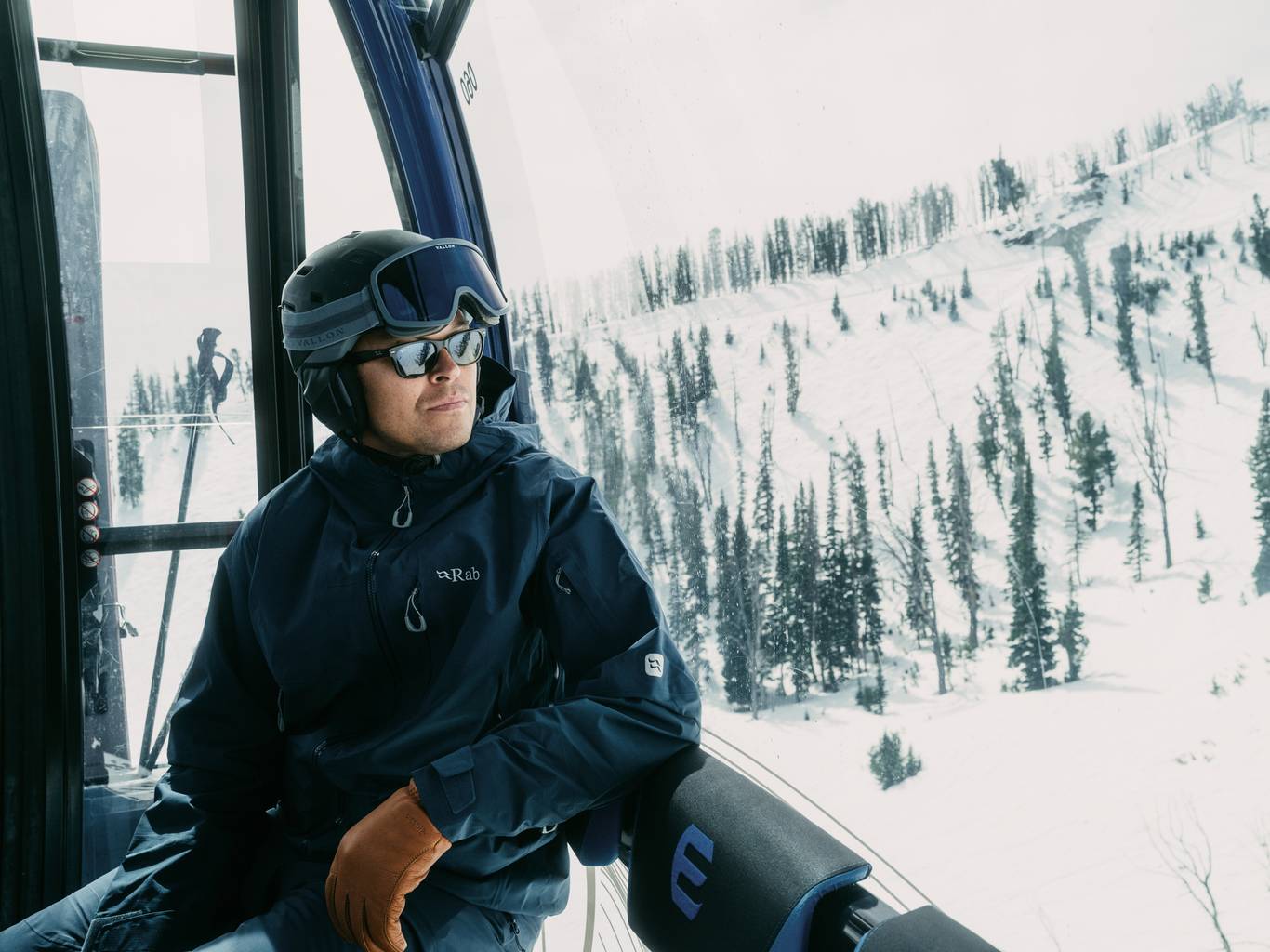 Man in ski gear riding the Explorer Gondola at Big Sky Resort