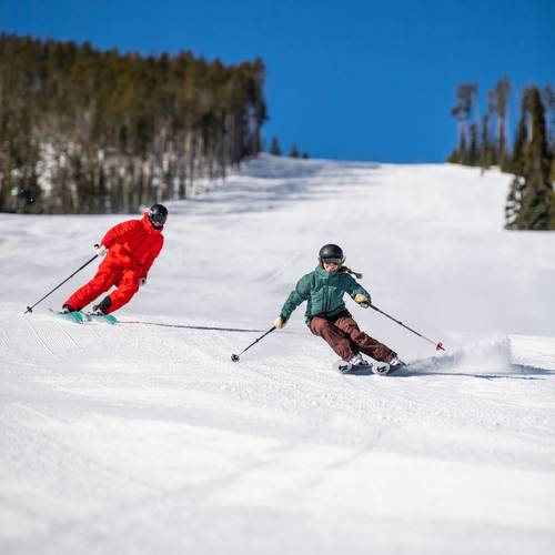 Skiers on a groomed run