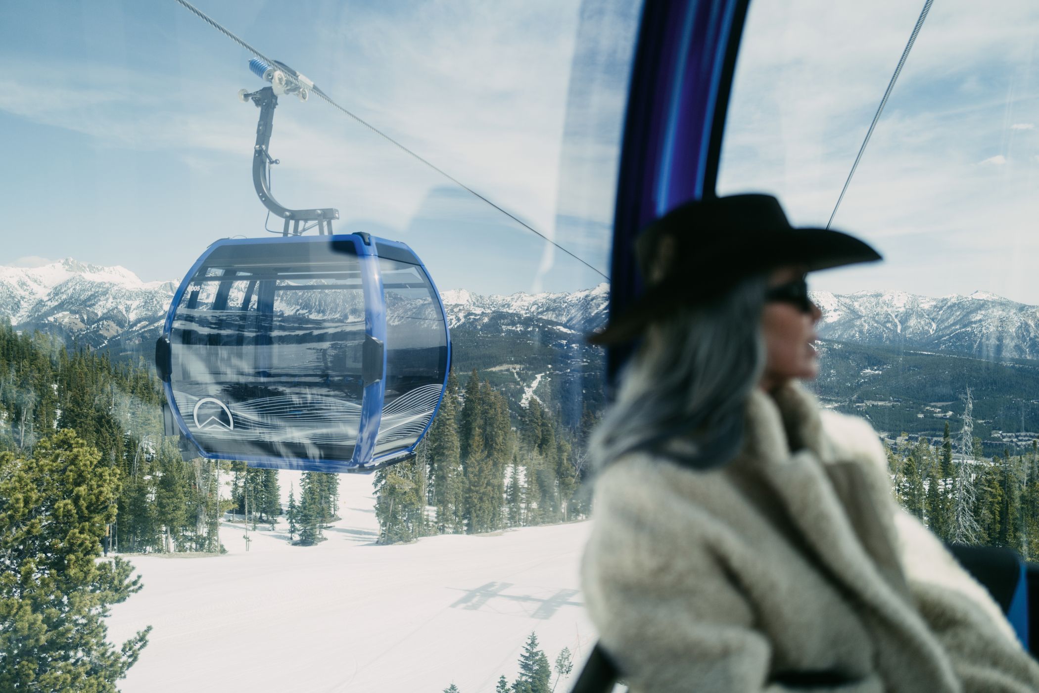 Woman riding the Explorer Gondola in winter