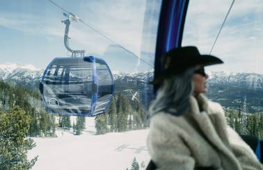Woman riding the Explorer Gondola in winter