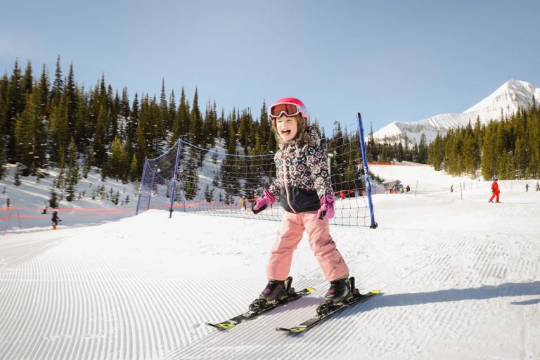 A girl laughing in ski gear