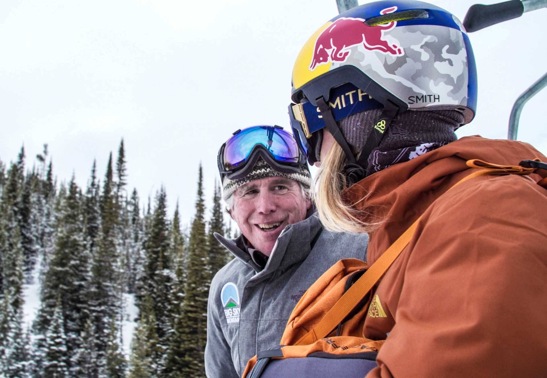 Dan Egan riding a chairlift with a skier