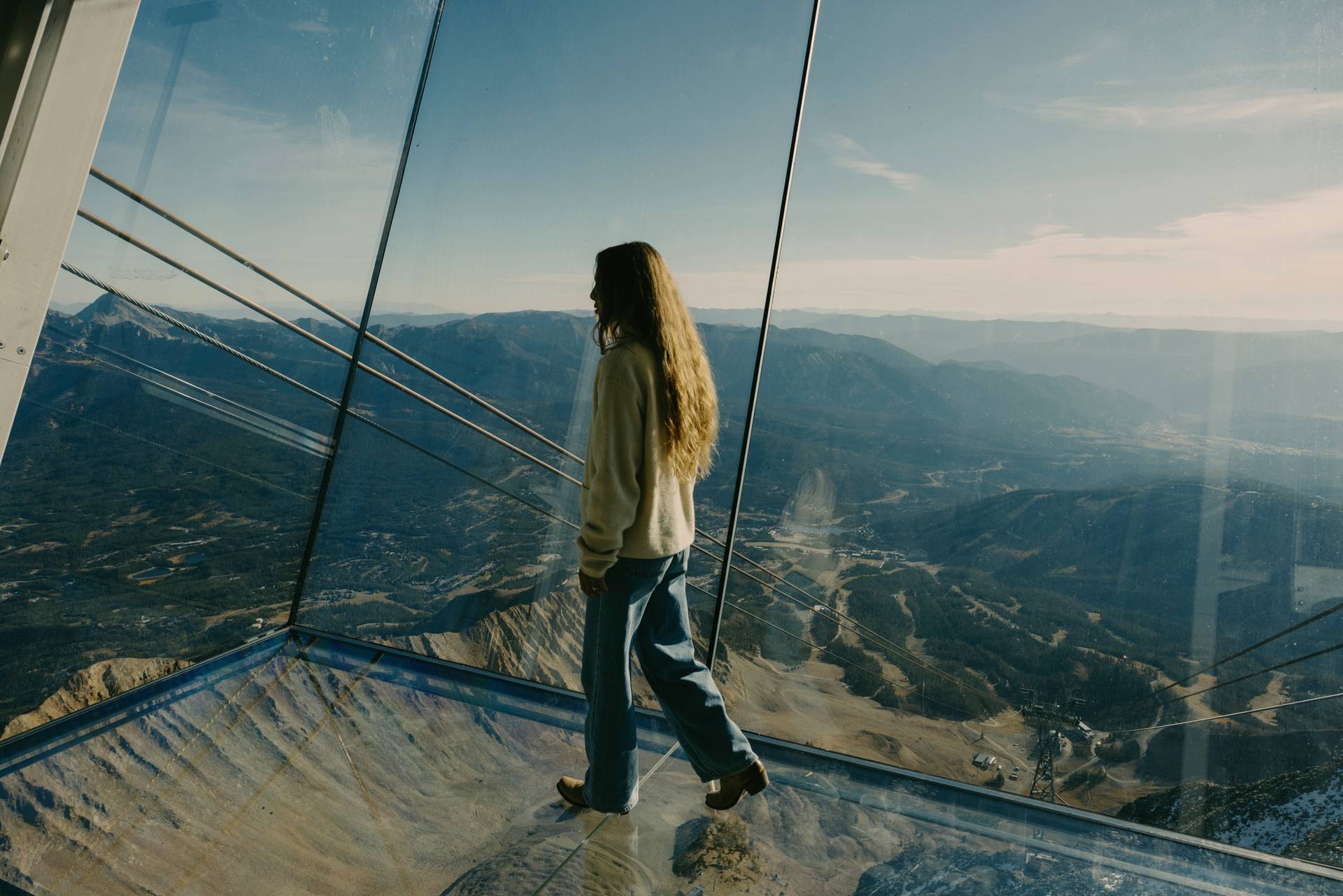 Woman walking on the glass floor at Kircliff in summer