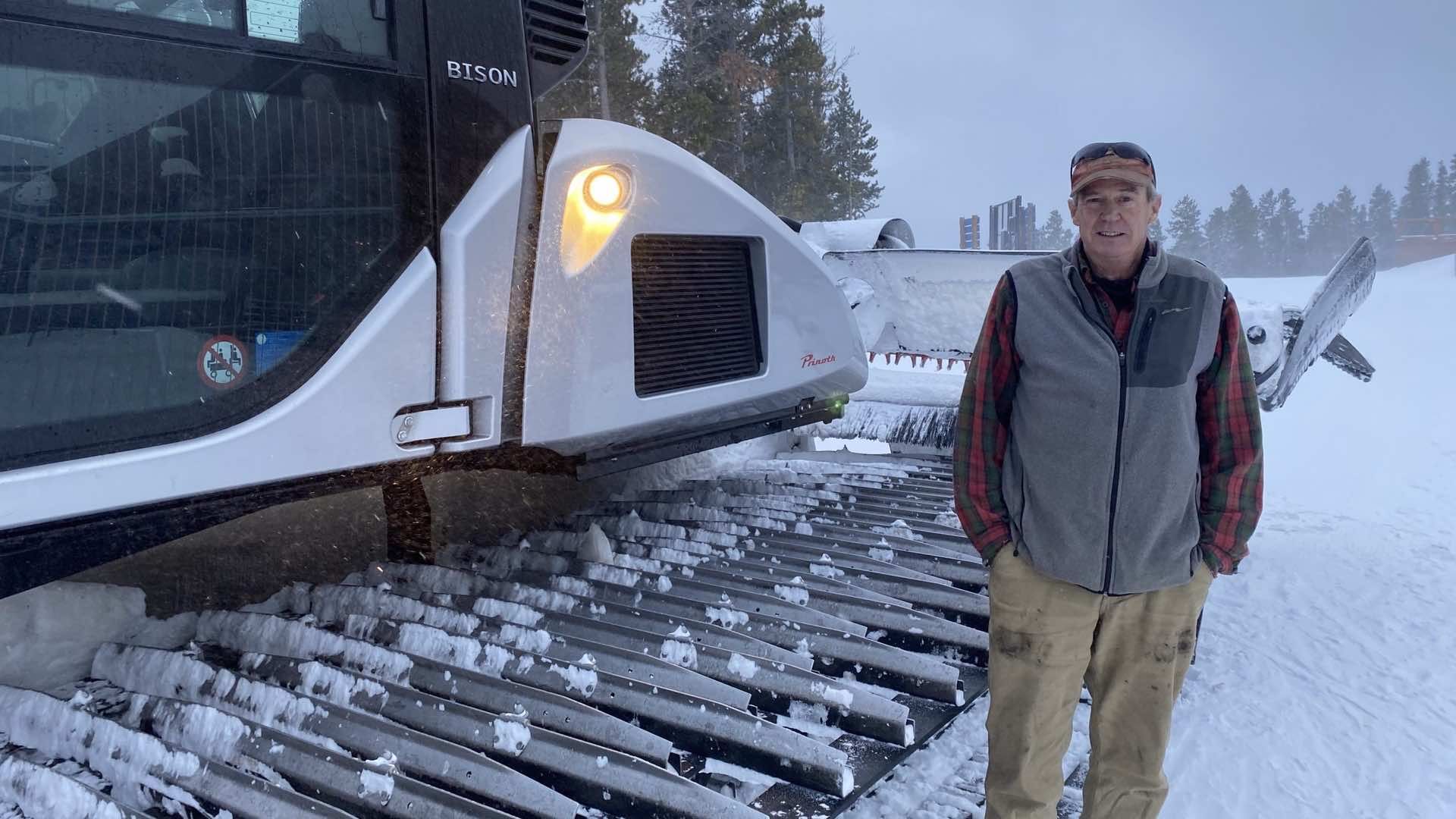 Ed stands in front of his snowcat in the early morning