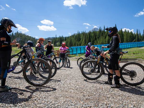 Bike Coach explains technique to a group of women