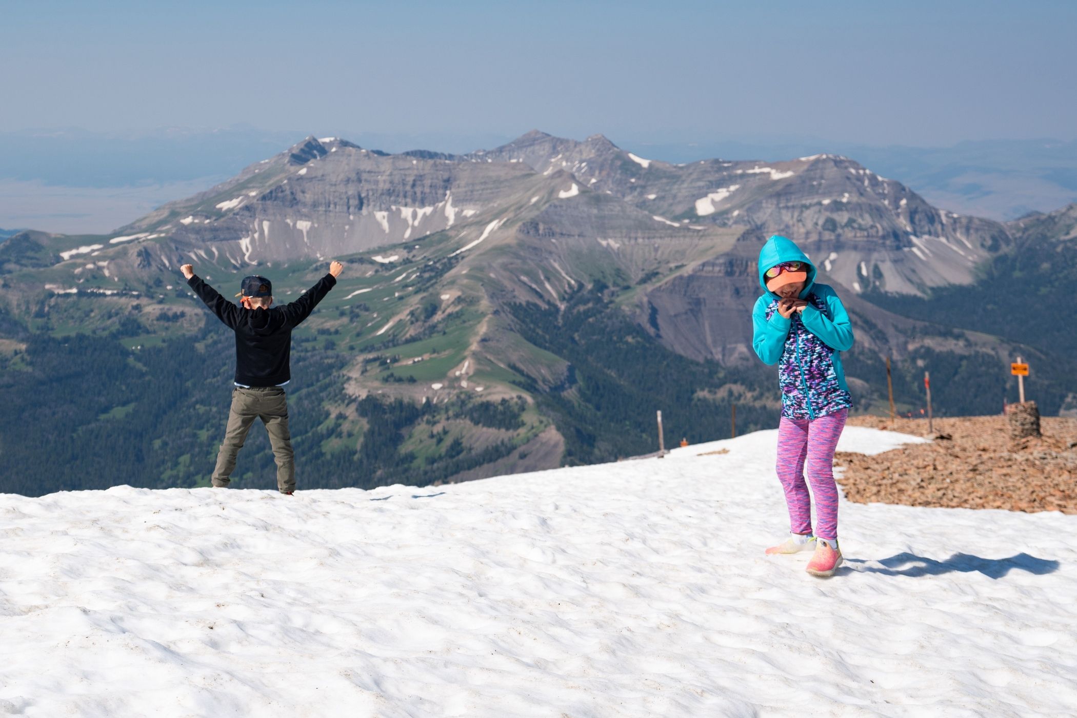 Kids playing in the snow at the top of Lone Peak