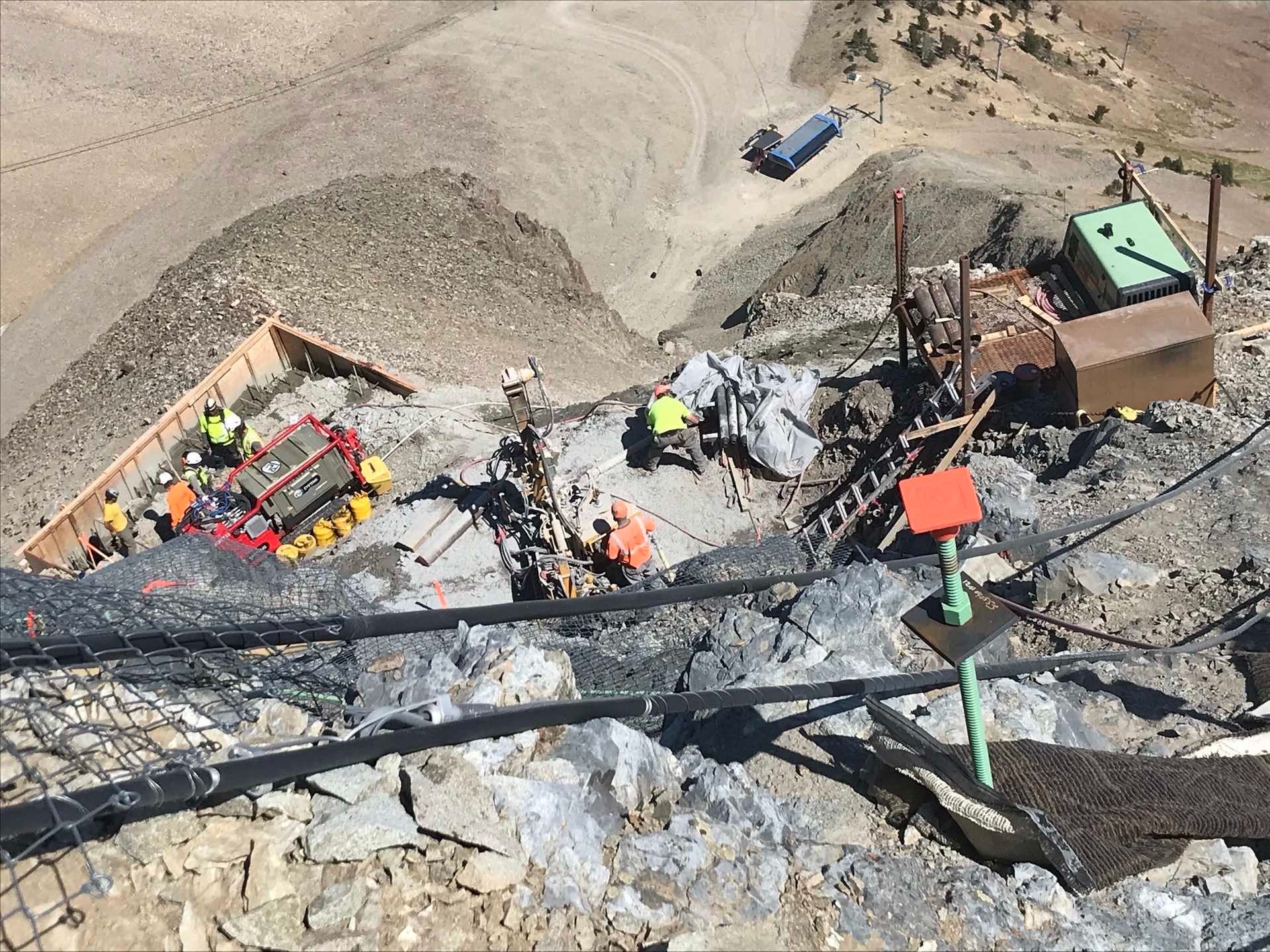 A Birds Eye shot of construction workers at the tram top station