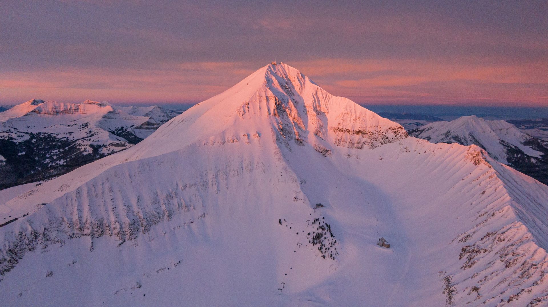 The top of Lone Peak lit up by the sunrise