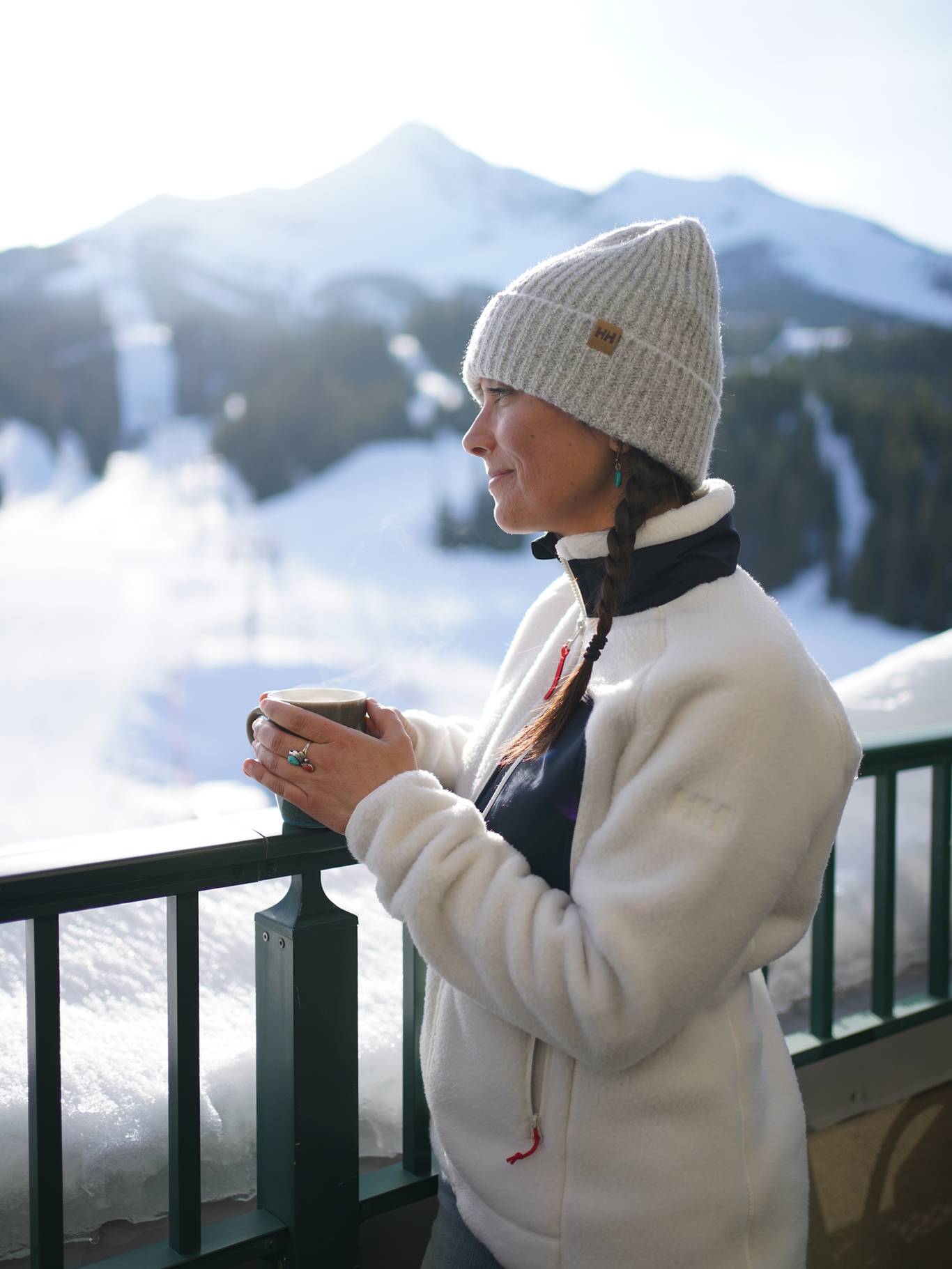 Woman in a fleece holdng a hot mug