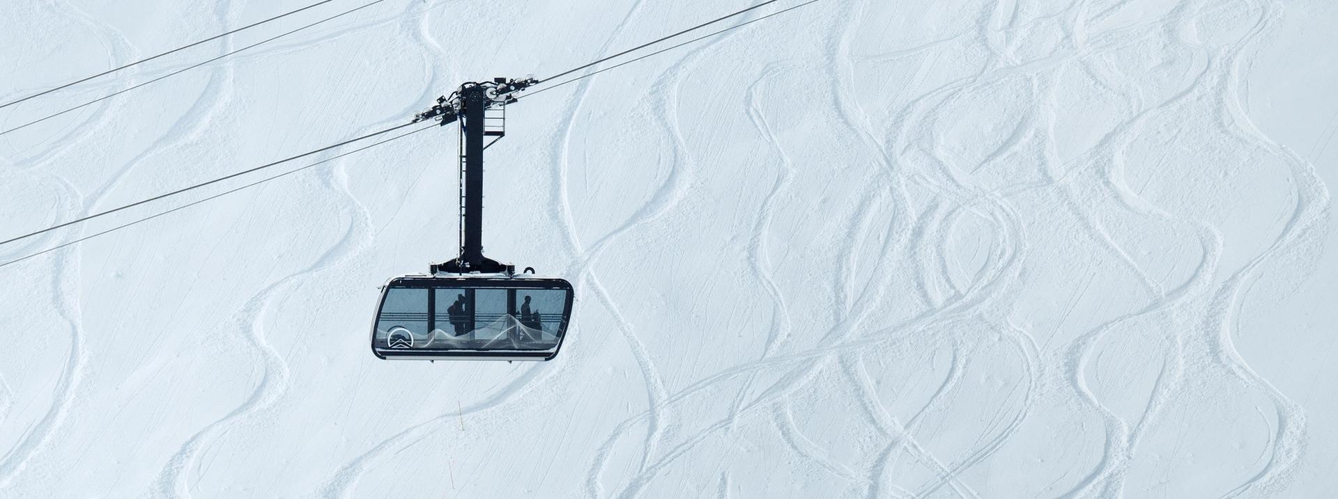 View of the Lone Peak Tram with ski tracks in the background