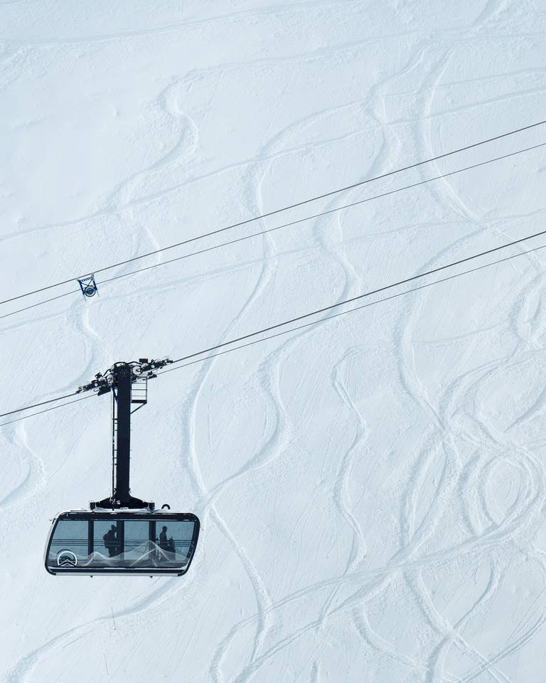 Lone Peak Tram with ski tracks in the background