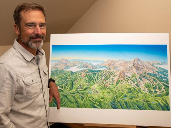 Smith in front of the new summer trail map