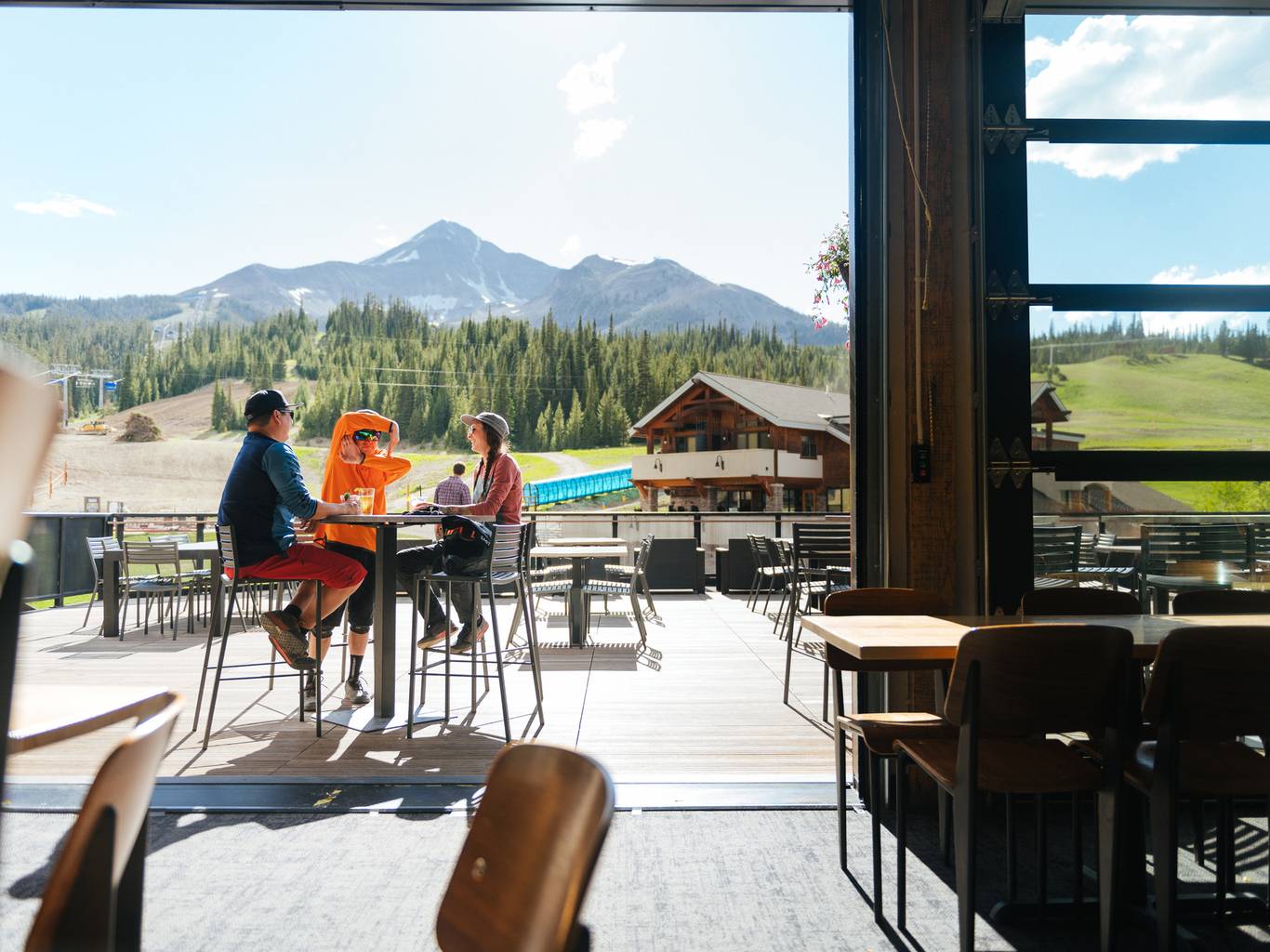 Group of people sitting at the Vista Deck with food and drinks