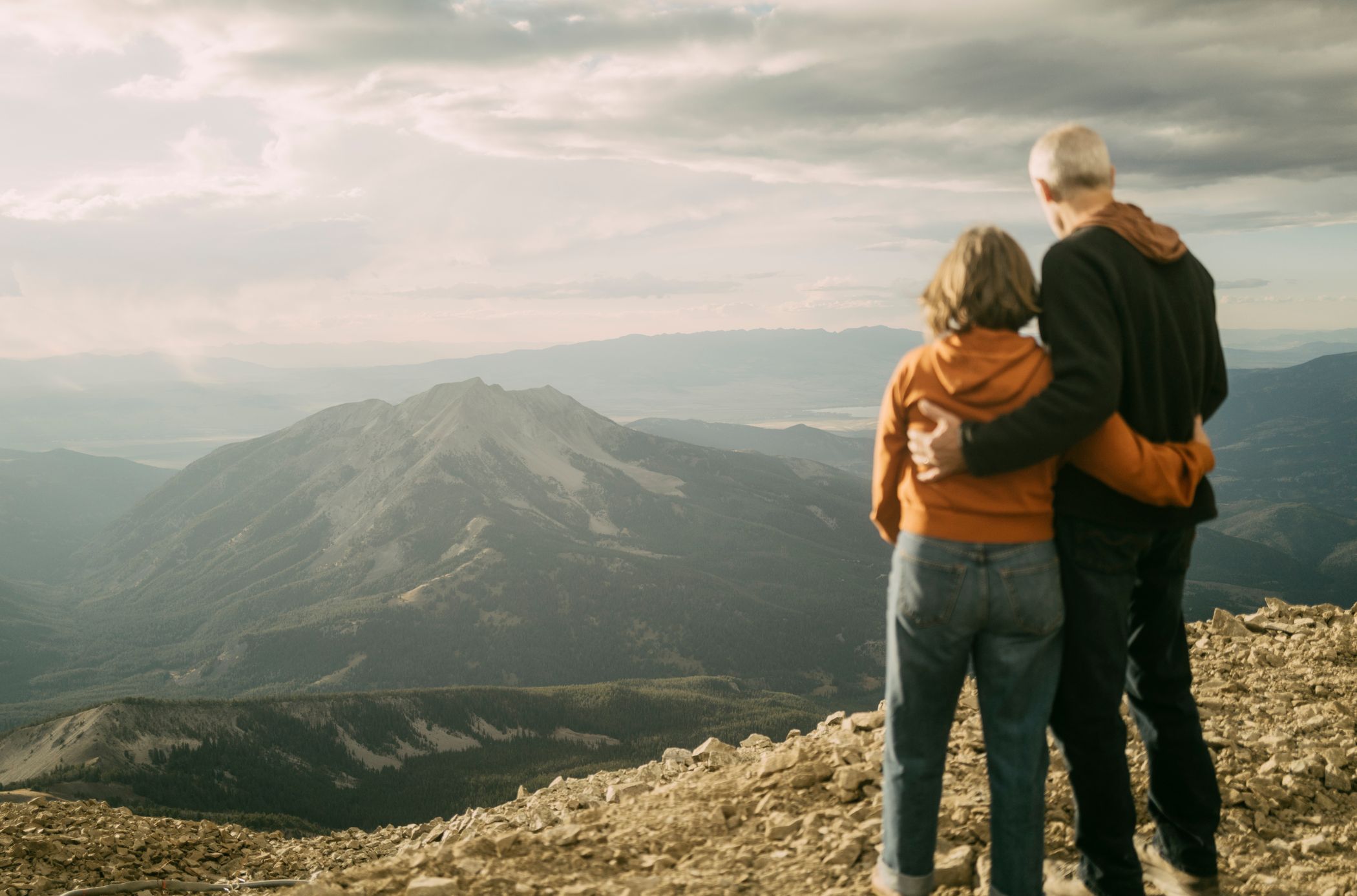 Couple looking out at a mountain range