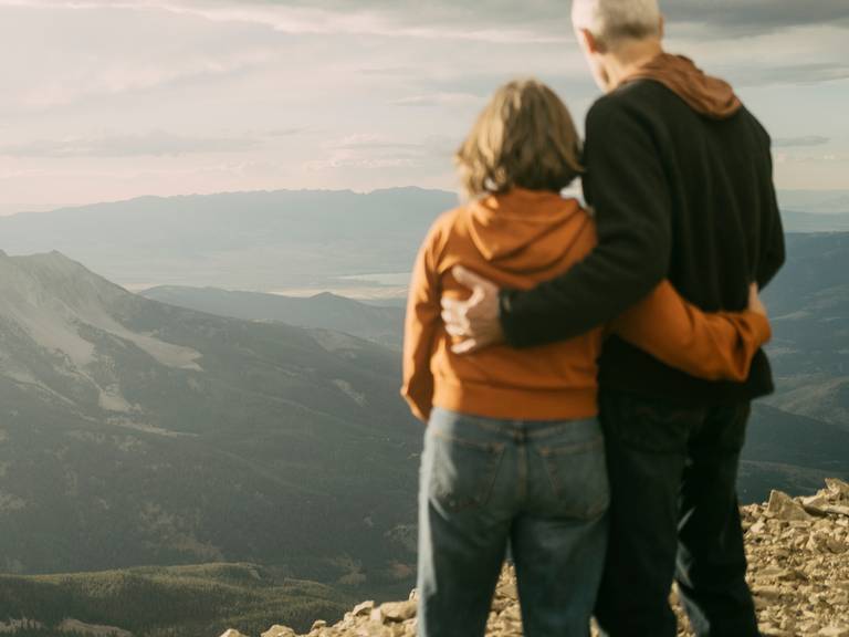 Couple looking out at a mountain range