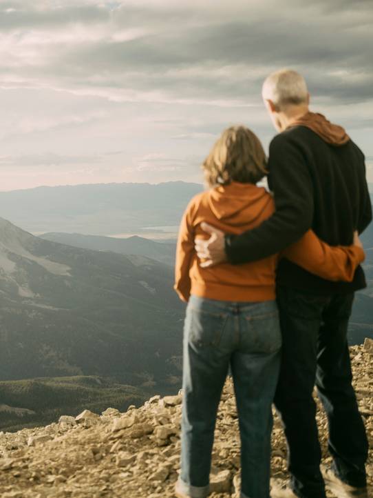 Couple looking out at a mountain range