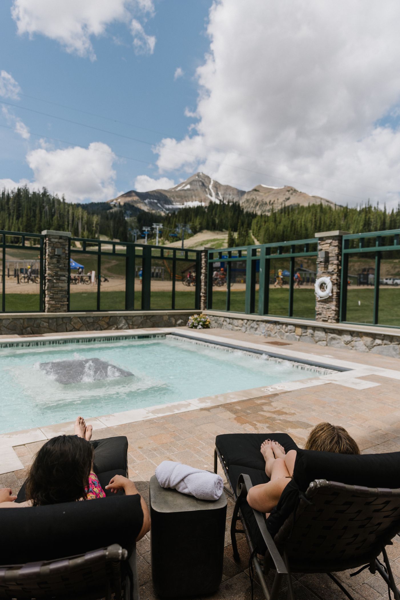 People lounging at the Summit Hotel pool in summer