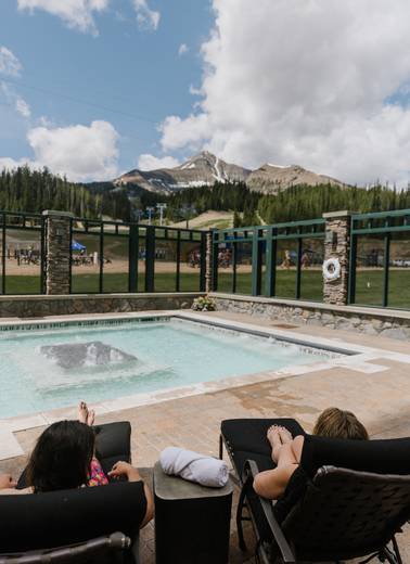 People lounging at the Summit Hotel pool in summer