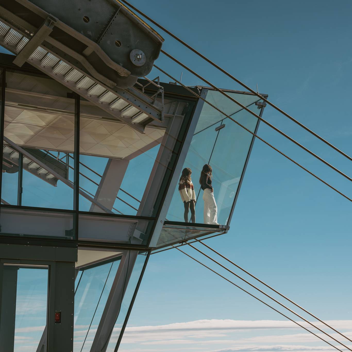 Two women standing on the glass overlook in Kircliff