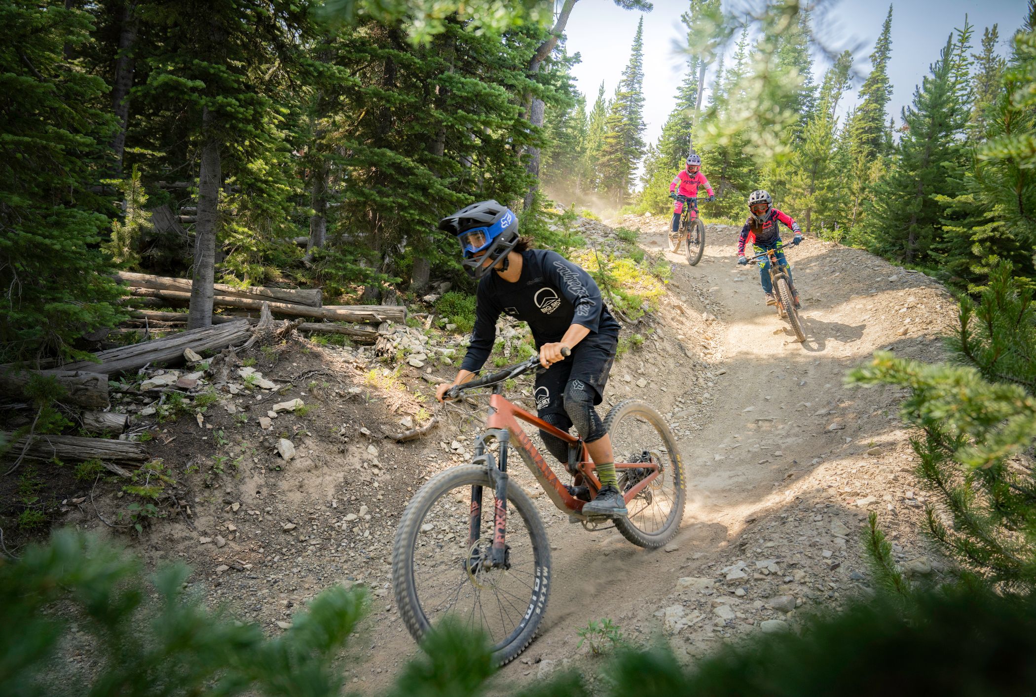 Mountain bike coach leading kids in a group lesson