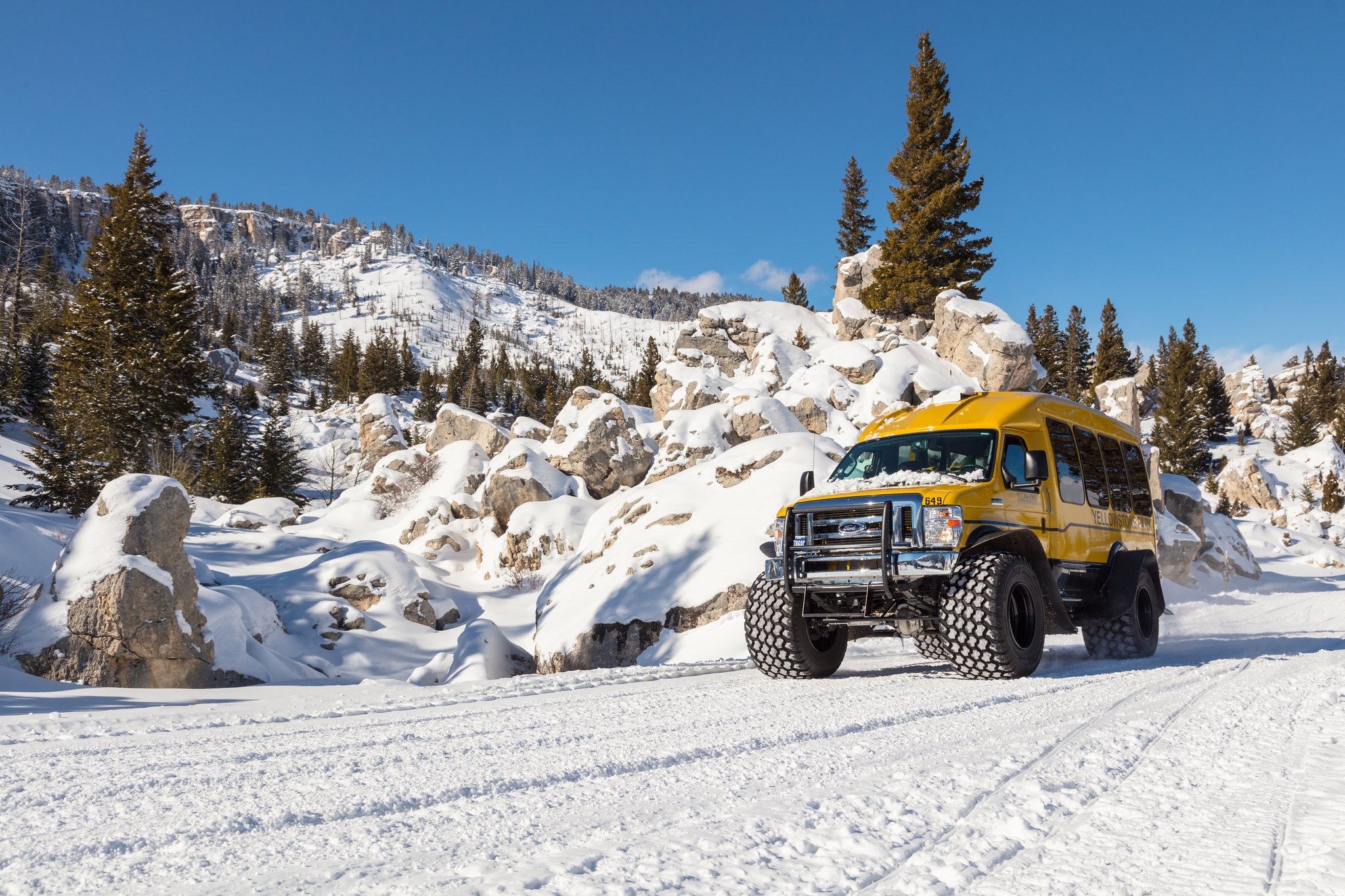Snow coach driving in Yellowstone National Park