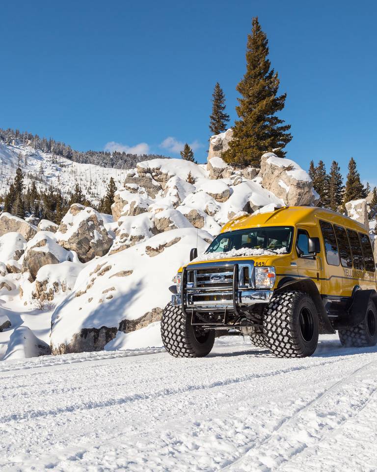 Snow coach driving in Yellowstone National Park