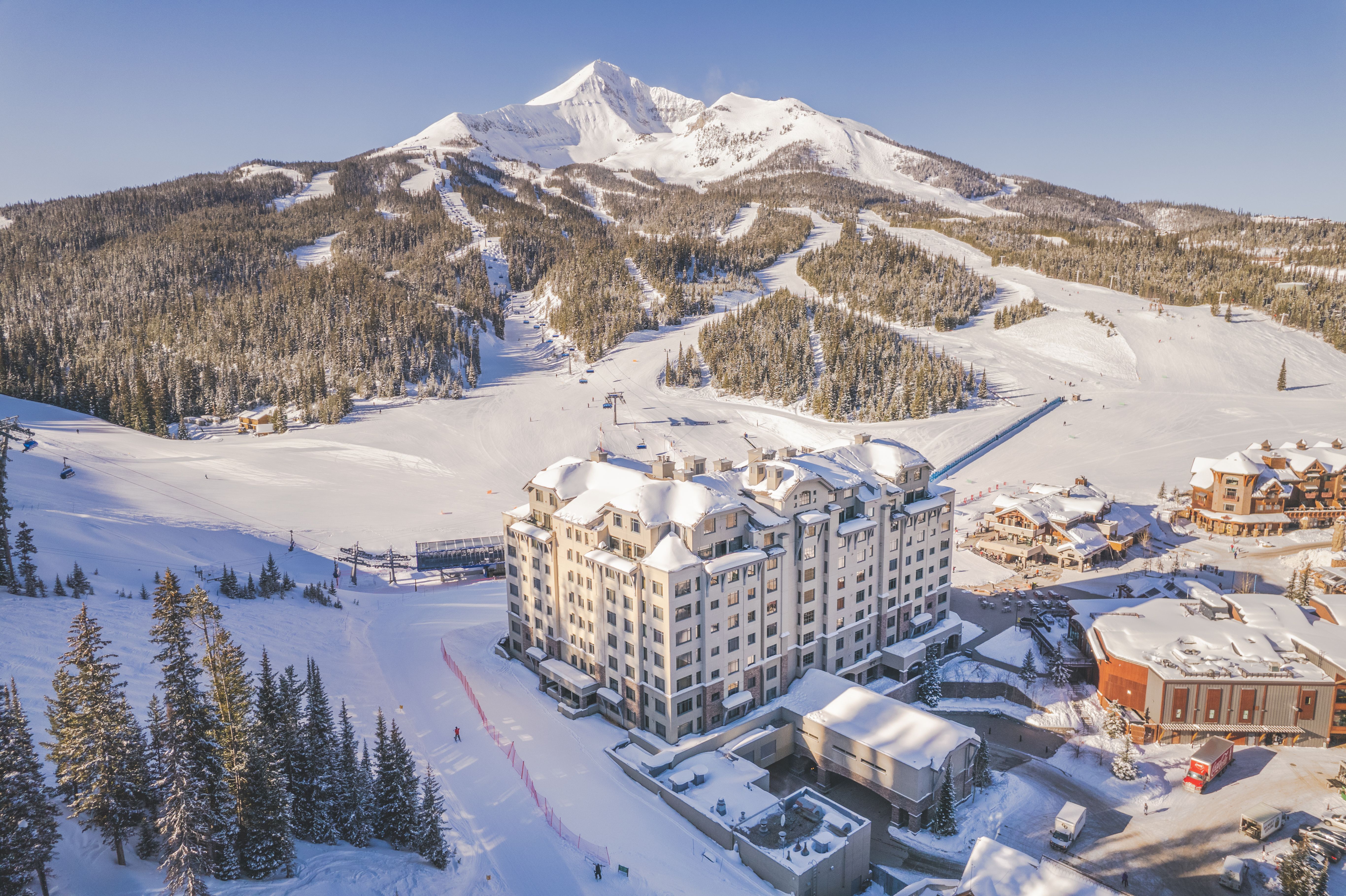 Summit Hotel exterior in winter with Lone Mountain in the background