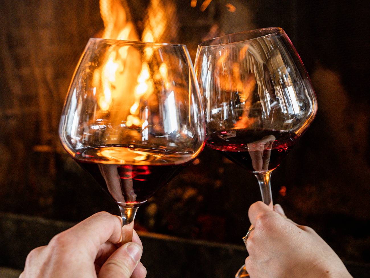 Wine glasses in front of a fireplace