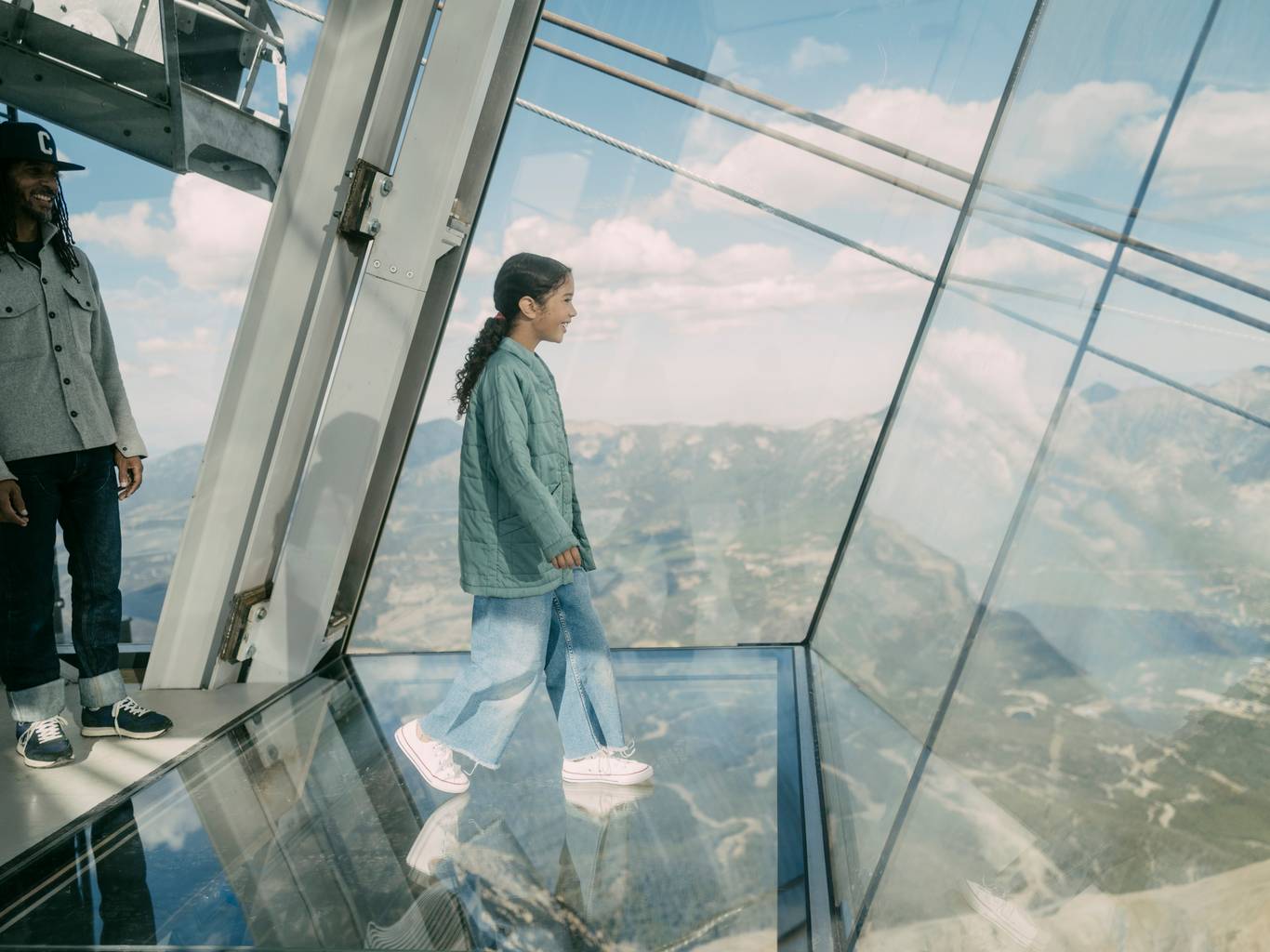 Girl walking out on the glass floor of Kirlciff