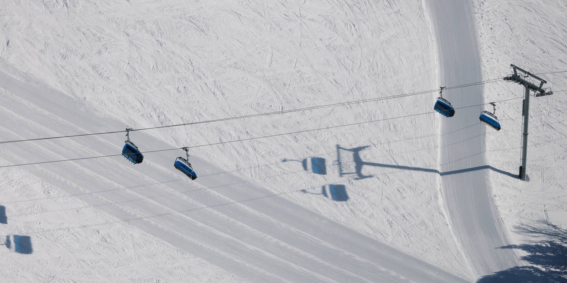 Chairlift with ski terrain in the background