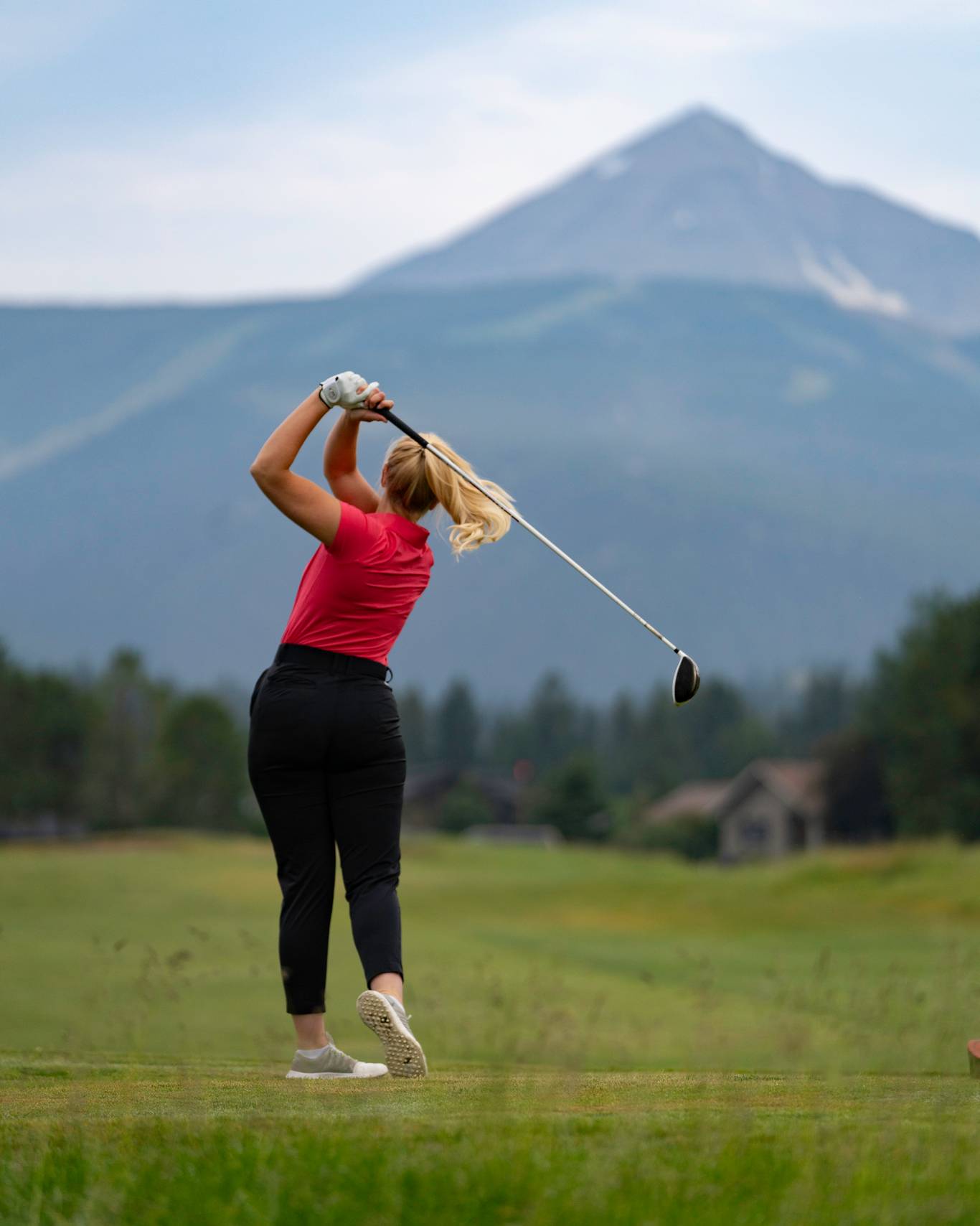 Golfer in front of Lone Mountain