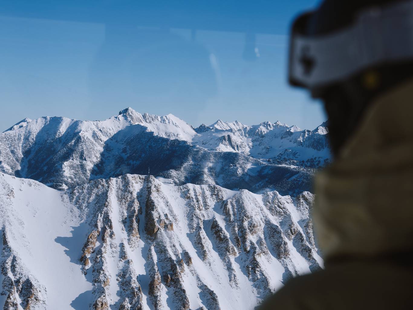 Skier looking out the window of the Lone Peak Tram