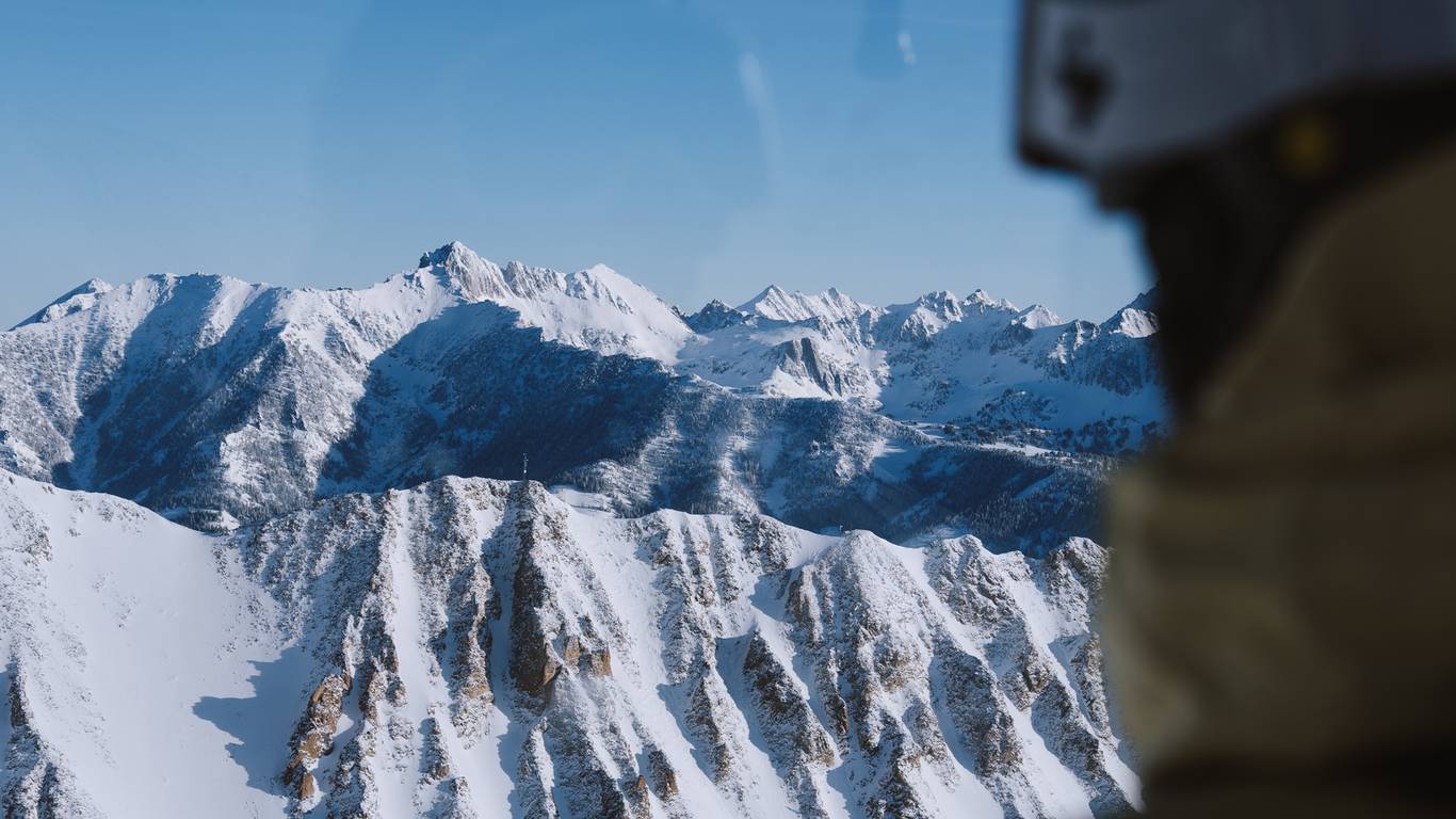 Skier looking out the window of the Lone Peak Tram
