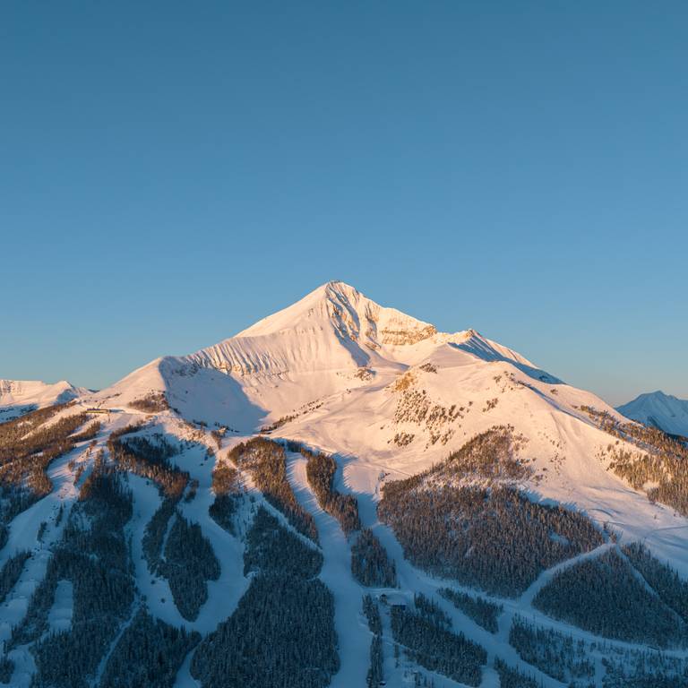 Family walking through Mountain Village in winter