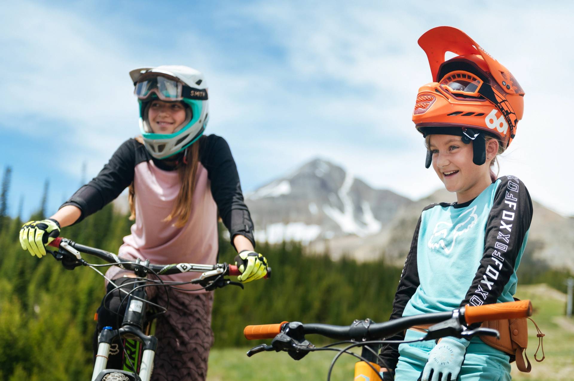 Girls on mountain bikes in front of Lone Peak