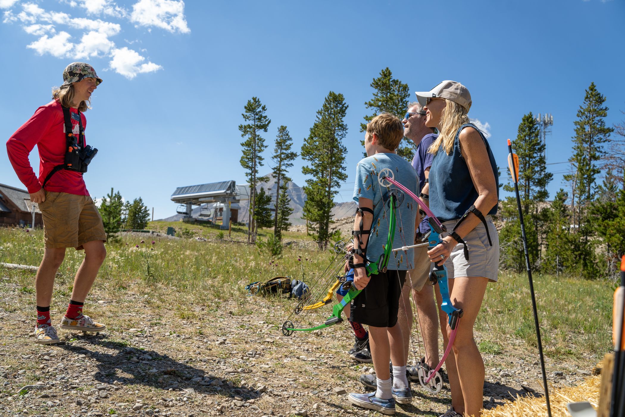 Family listening to an archery instructor