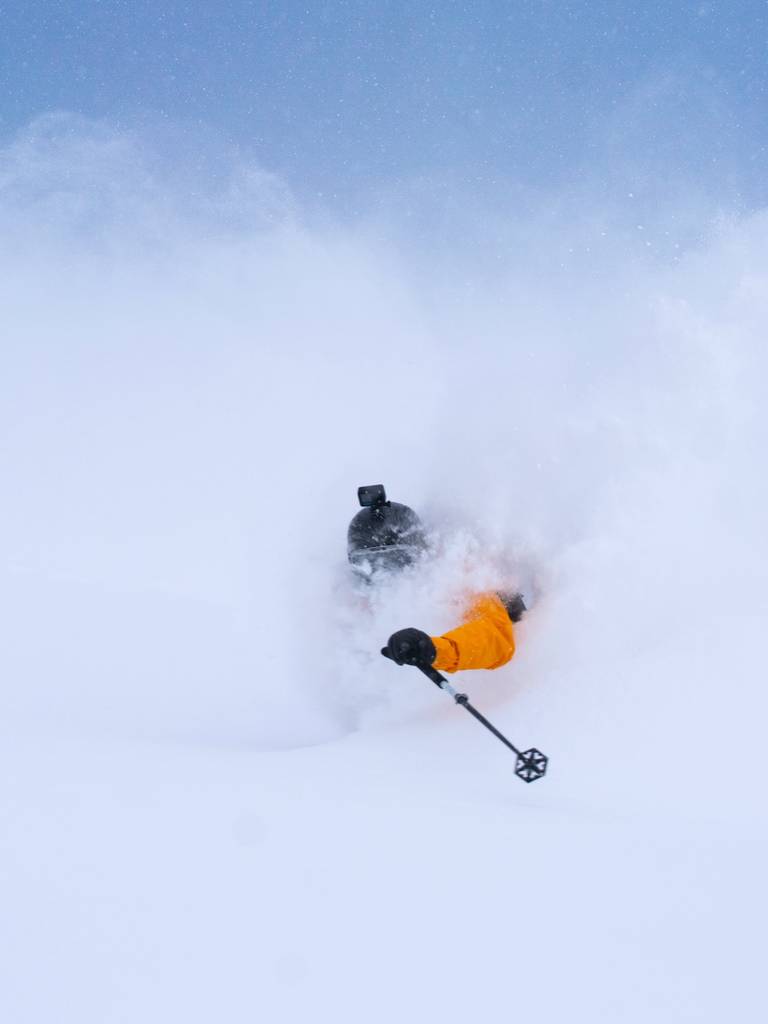 Skier in powder with a helmet-mounted GoPro