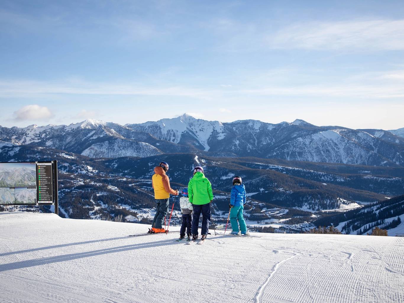 Family skiing looking out at the views on a groomed run